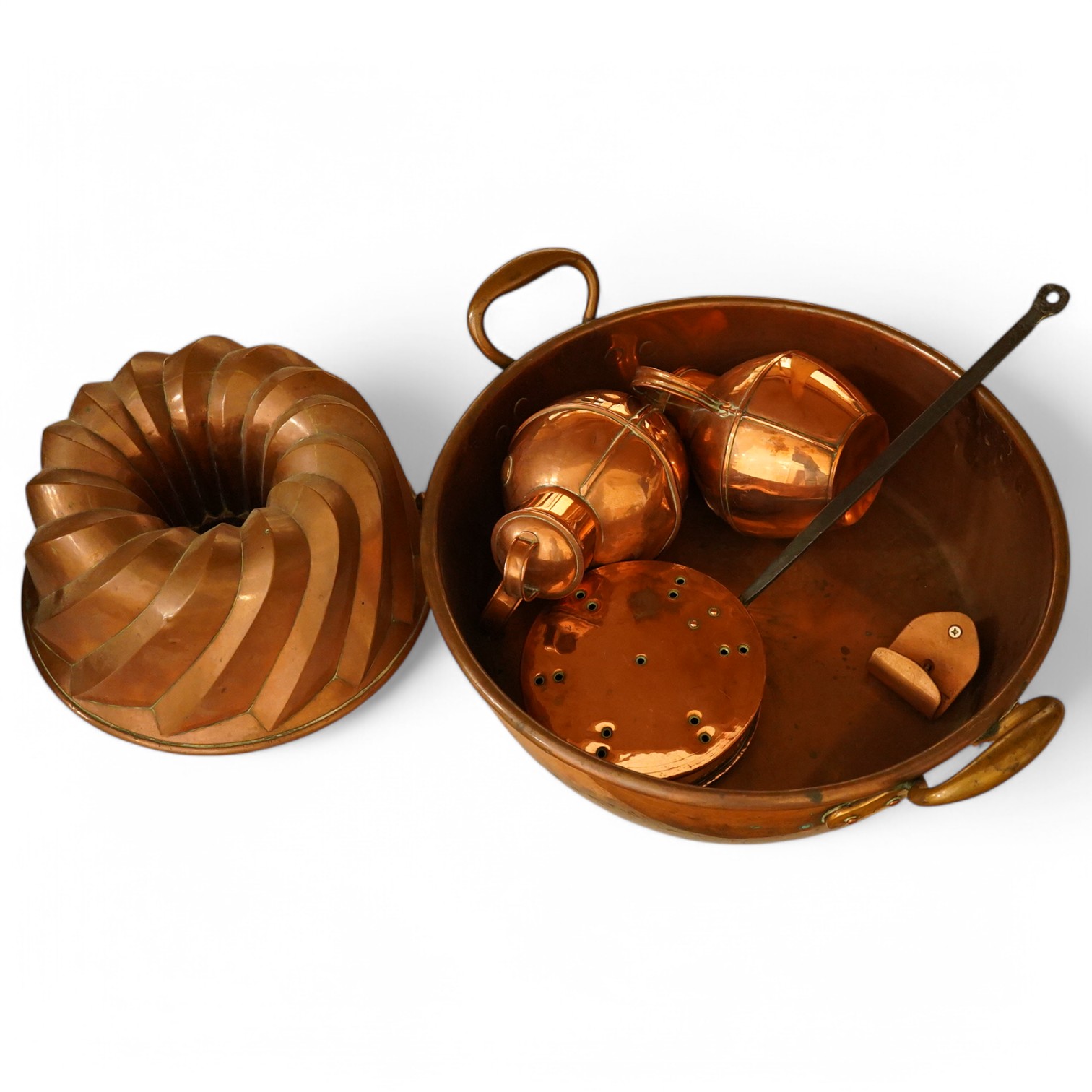 Five copper items including a large jelly mould, a two handled pan, two jugs and a chestnut roaster, pan 41cm diameter. Condition - fair to good